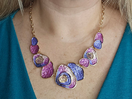 tatement necklace, abstract jewelry, bold design, purple and pink necklace, gold chain, artistic jewelry, boho chic, modern accessories, fashion jewelry, vibrant necklace.
