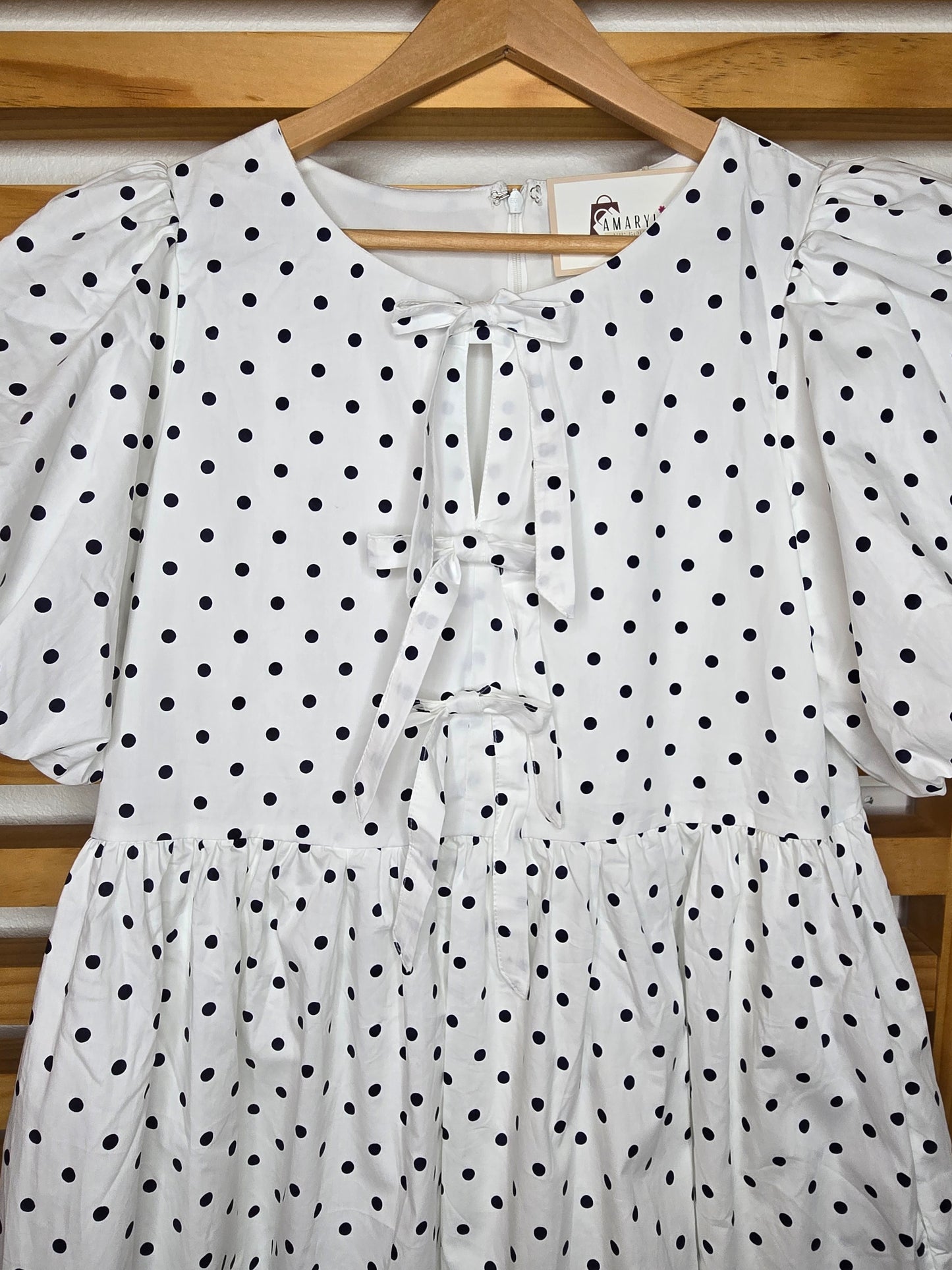 puff sleeve dress, polka dot dress, ruffle hem, front bow, lined dress, classic style, elegant outfit, feminine fashion, lightweight fabric, chic and timeless, amarylisvipboutique, boutiqueonline