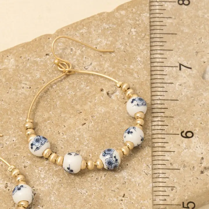 floral earrings, ceramic jewelry, teardrop earrings, metallic beads, boho chic, statement accessories, feminine style