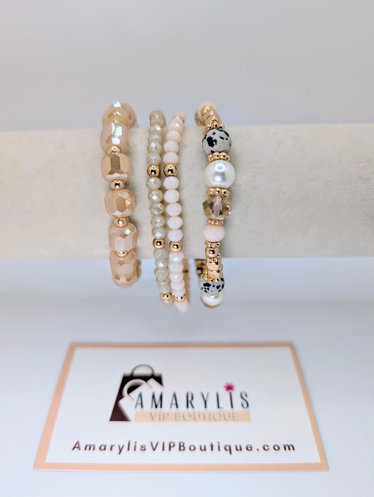 Set of beaded bracelets on a white surface with 'Amarylis VIP Boutique' branding.