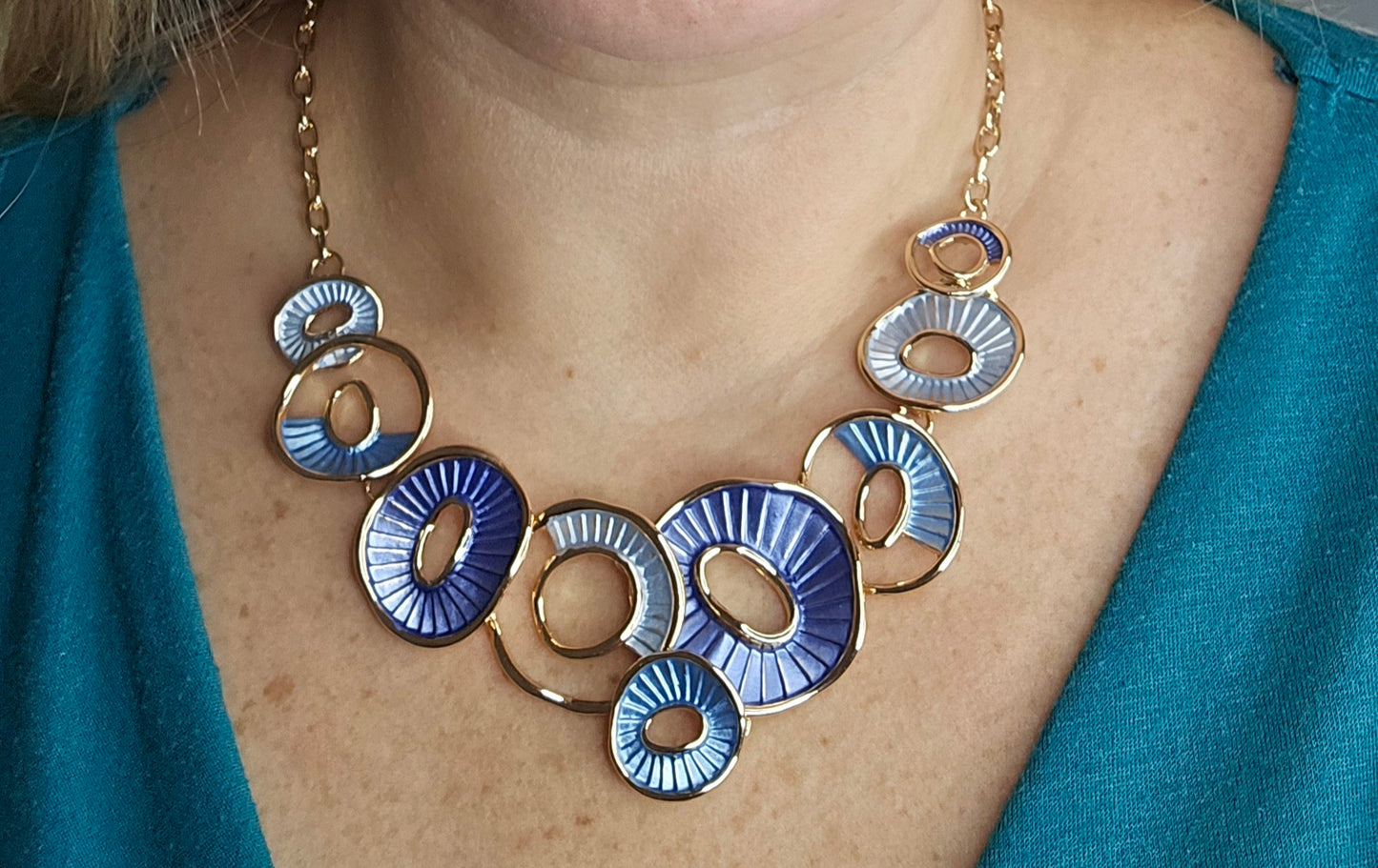 #GoldNecklace #GeometricJewelry #BlueTonedNecklace #StatementNecklace #ModernAccessories #ChicJewelry #FashionJewelry #ContemporaryStyle #GoldJewelry #ElegantAccessories #TrendyNecklace #BoldNecklace