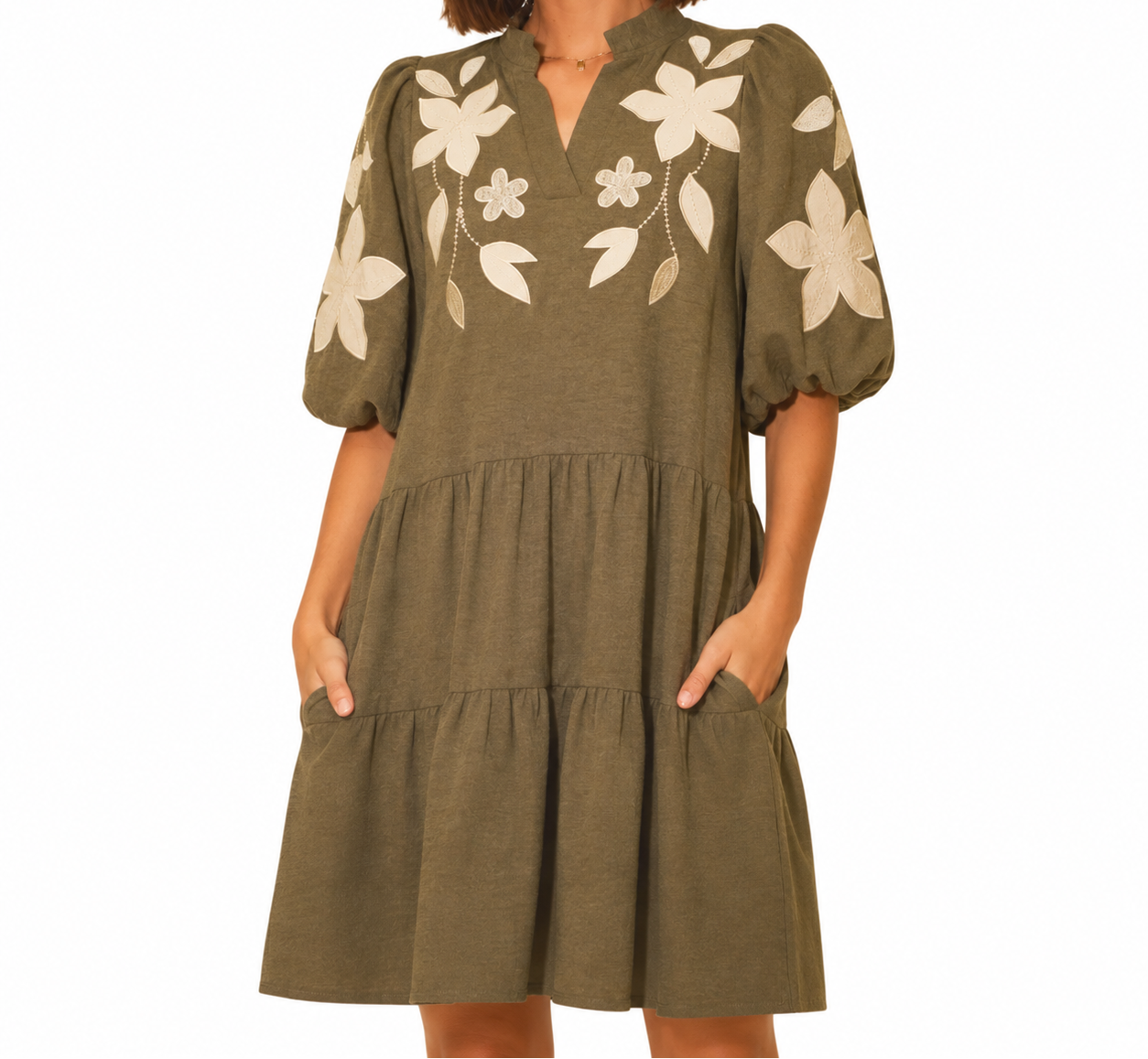 Effortless boho style meets everyday comfort in this olive tiered dress with statement floral embroidery, puff sleeves, and convenient side pockets.