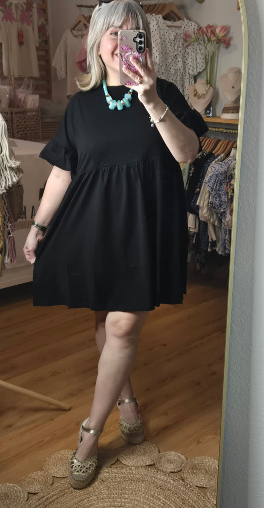 Short black cotton dress with round neckline, ruffle sleeves, and ruffle hem detail