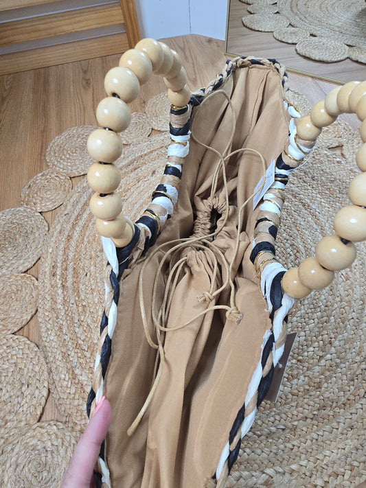 Straw crescent tote bag with round handles and inner lining with drawstring closure