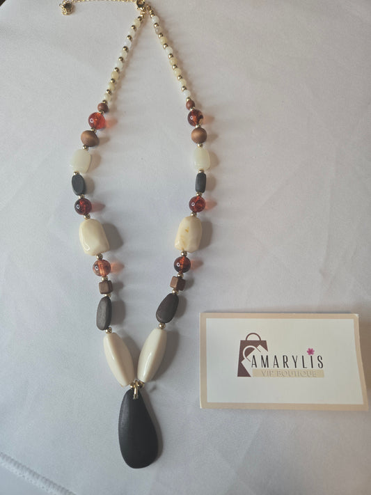 A timeless wood bead necklace with a graceful teardrop pendant, designed to bring natural beauty and effortless elegance to your wardrobe.