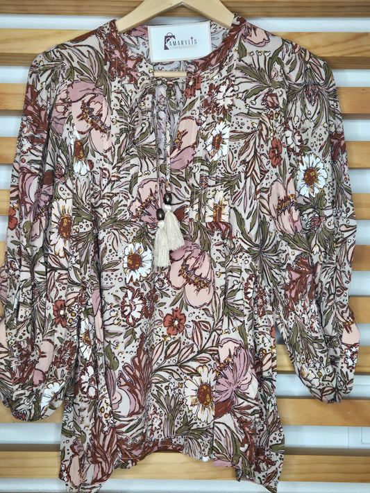 Soft and feminine peasant-style blouse featuring a delicate floral print, 3/4 length puff sleeves, and a tassel-tie neckline. Designed for effortless bohemian