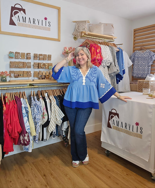 Blue blouse with embroidery and plunging V-neck, featuring contrasting trim
