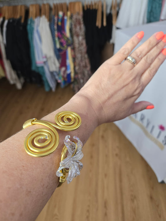 Handcrafted adjustable gold-tone bracelet featuring a clear flower-shaped charm, lightweight waterproof design, and artisan-crafted details for everyday wear.