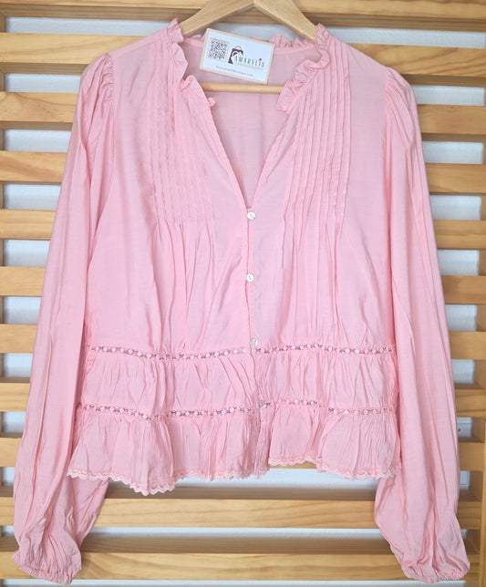 Women’s pink blouse with V-neckline, button front, lace-trimmed ruffles, delicate pin-tuck details, and long balloon sleeves with elastic cuffs.