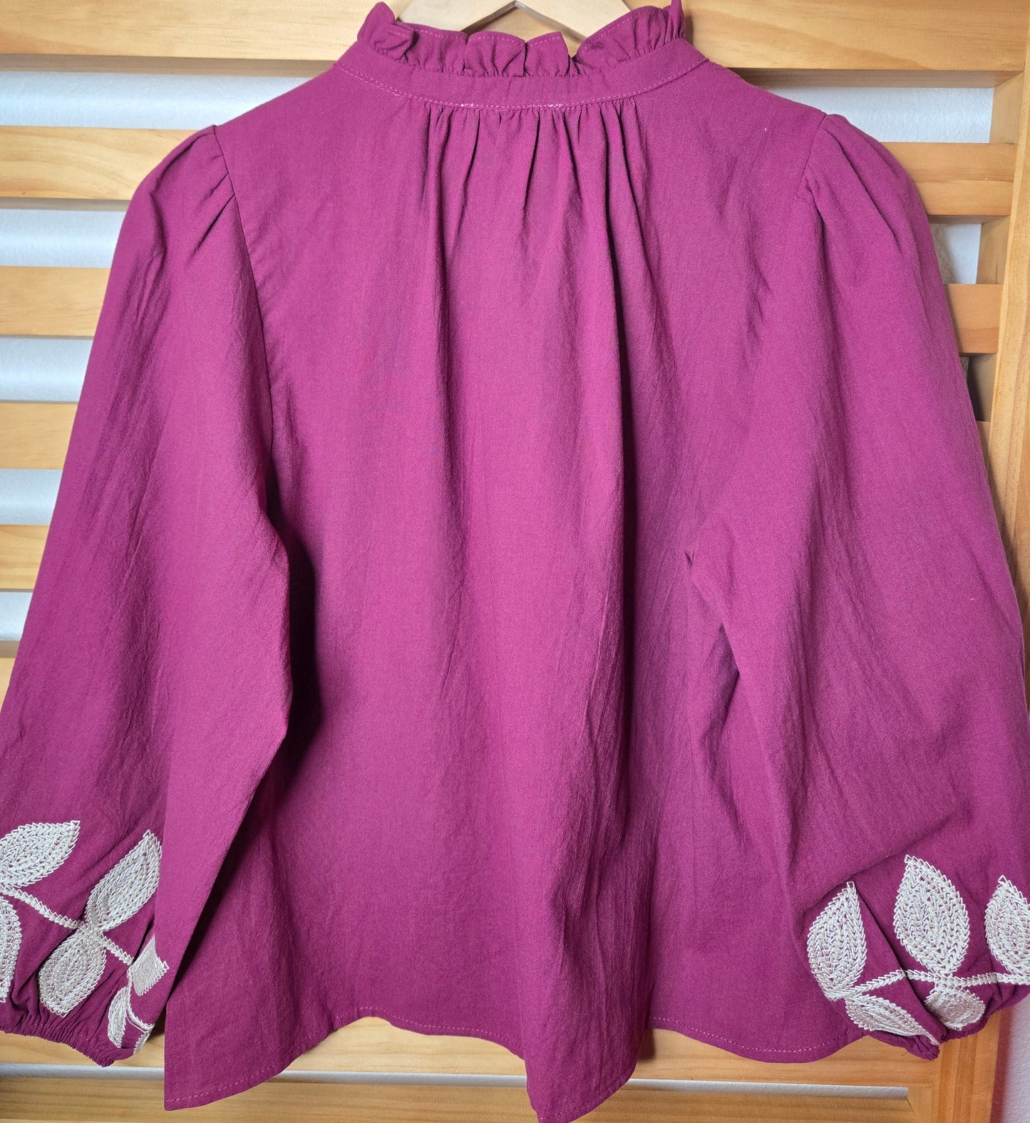 Magenta cotton blouse with floral embroidery, button-down front, and long sleeves