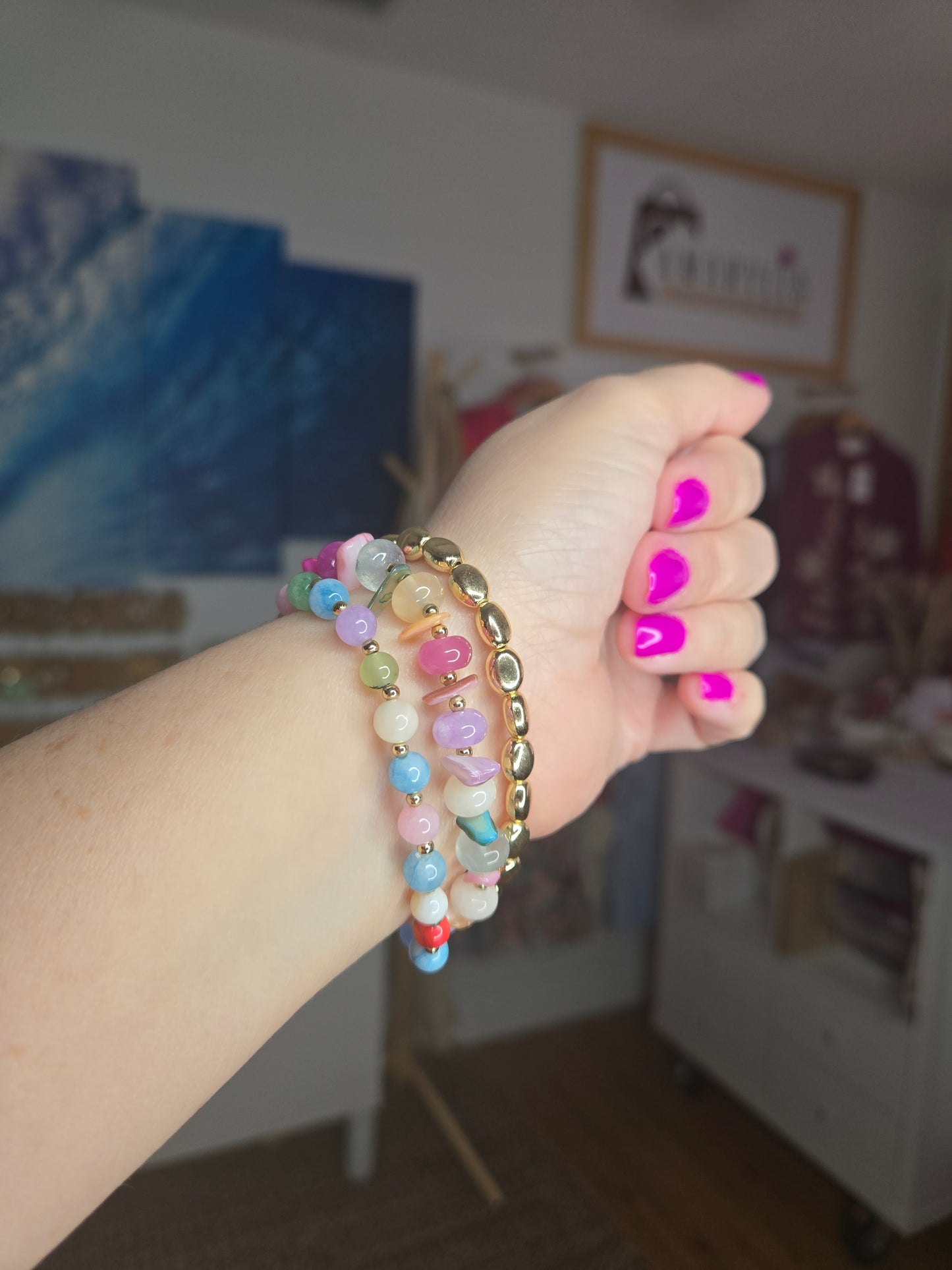 Metallic stone and multicolor beaded bracelet set featuring pearl accents and layered design details.