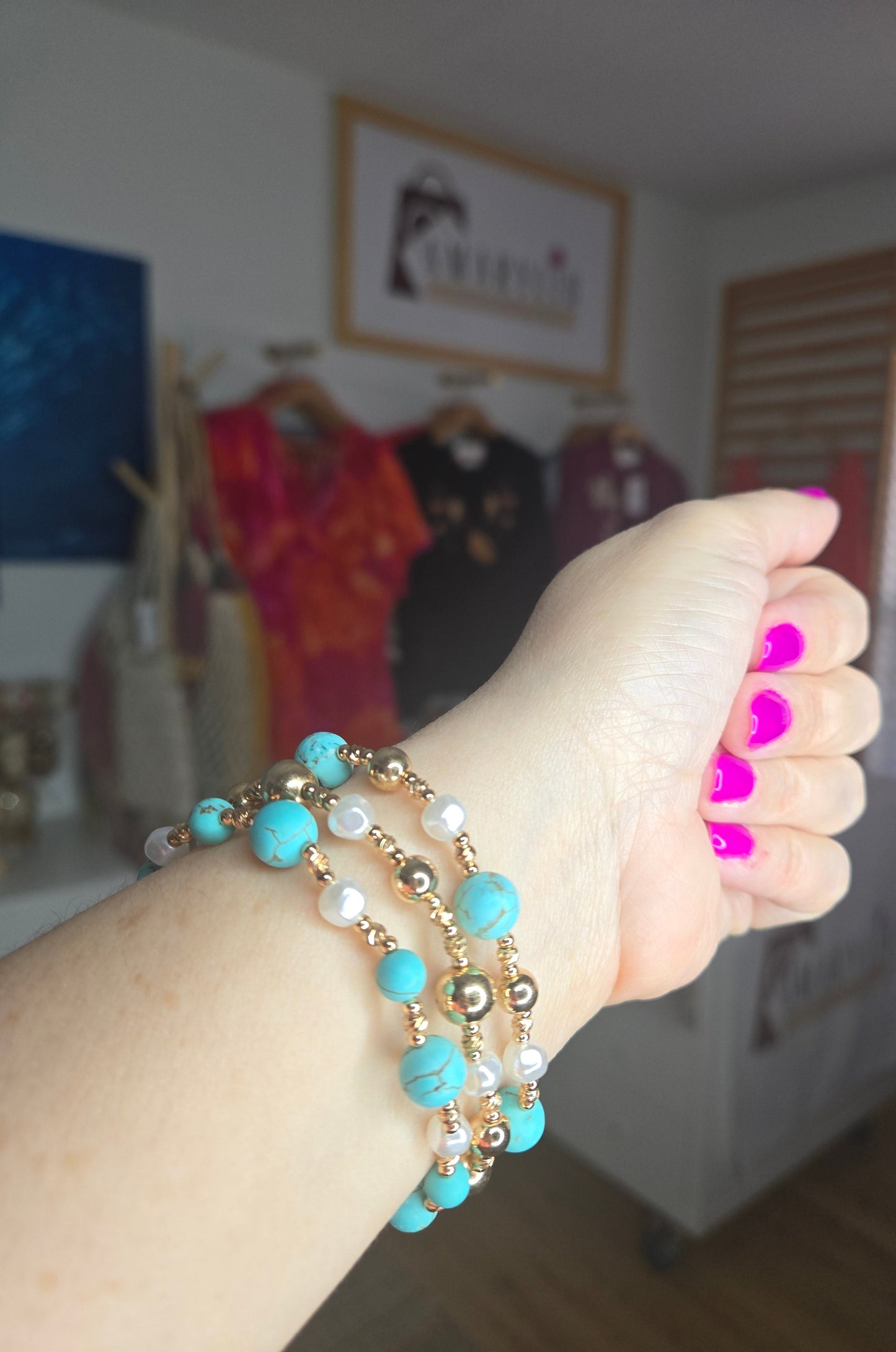Turquoise stone, metallic, and pearl beaded bracelet set with layered design and textured detailing.