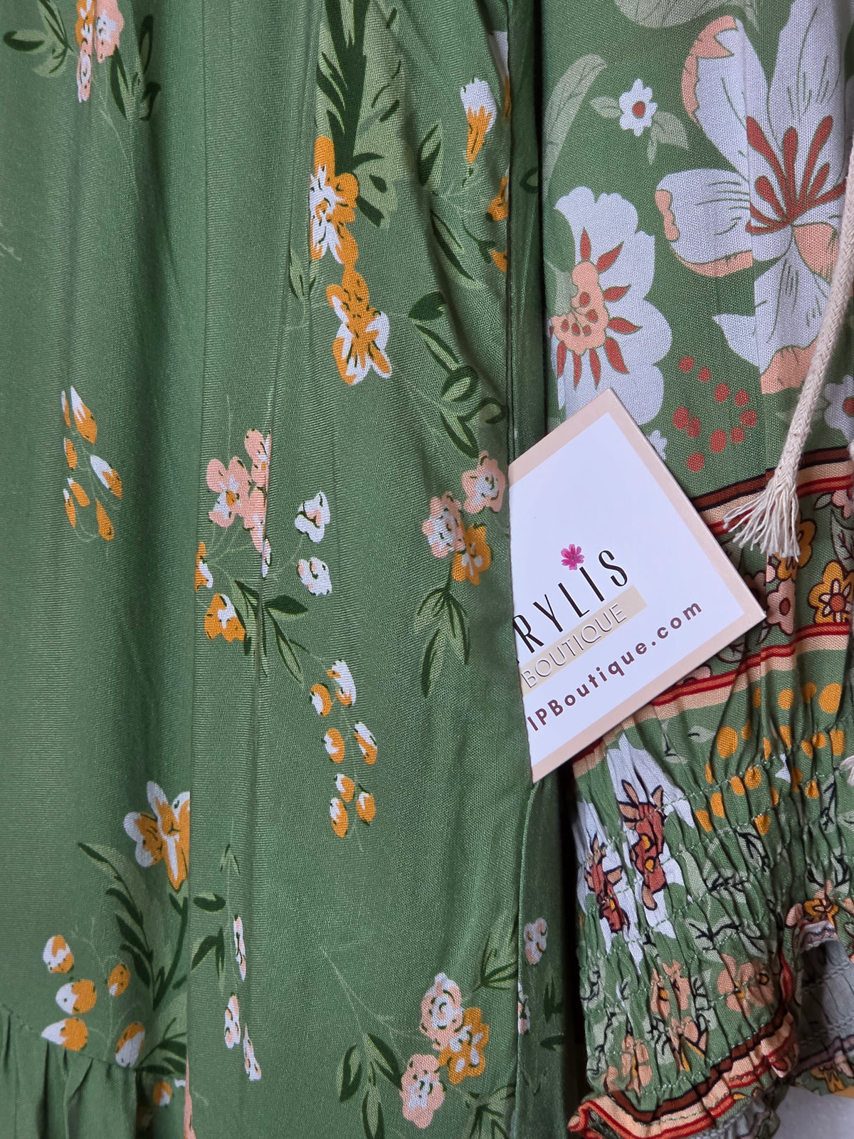 Floral print maxi dress featuring a side pocket with matching floral fabric and contrasting border print detail.