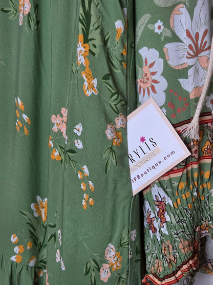 Floral print maxi dress featuring a side pocket with matching floral fabric and contrasting border print detail.