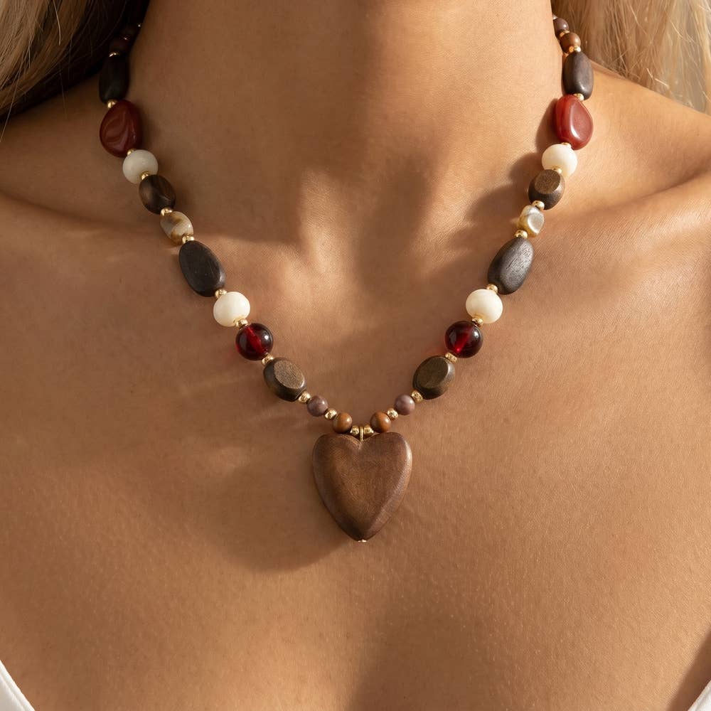 Wooden bead necklace featuring a heart-shaped pendant with a feminine and bohemian-inspired design.