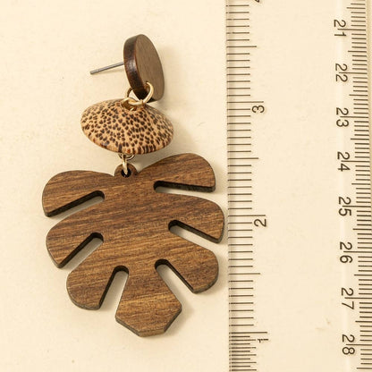 Natural wooden monstera leaf dangle earrings featuring an intricate cutout leaf design with lightweight dangling hooks.