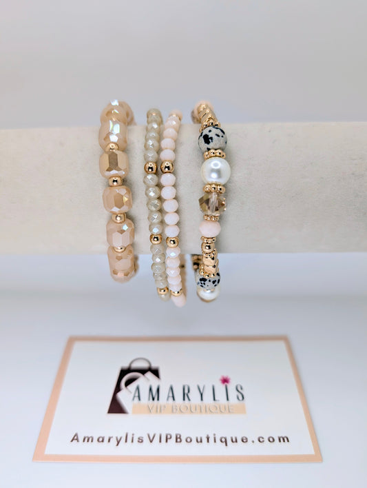 Set of beaded bracelets on a white surface with 'Amarylis VIP Boutique' branding.