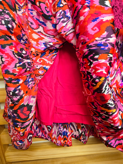 This vibrant mini dress features a playful tassel tie neck and an abstract print. The ruffled hem adds a dynamic touch, while the soft lining ensures comfort and a smooth fit.