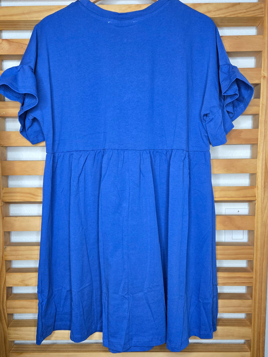 Short blue cotton dress with round neckline, drop shoulders, short ruffle sleeves, and ruffle hem in a relaxed fit design.