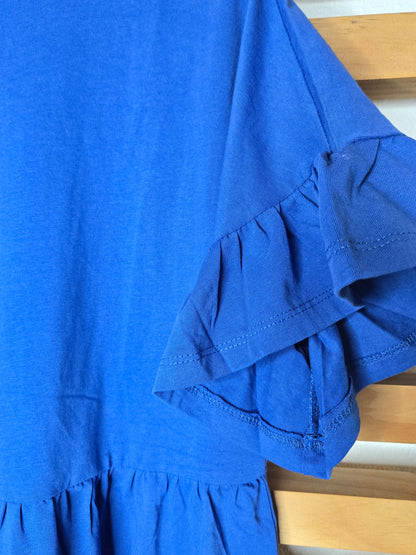 Short blue cotton dress with round neckline, drop shoulders, short ruffle sleeves, and ruffle hem in a relaxed fit design.