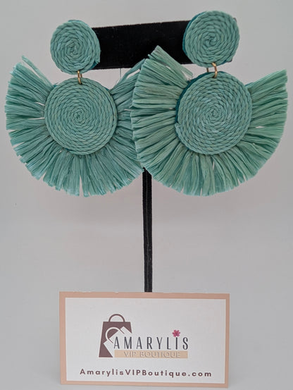 Teal raffia earrings on a hanger with Amarylis VIP Boutique label.