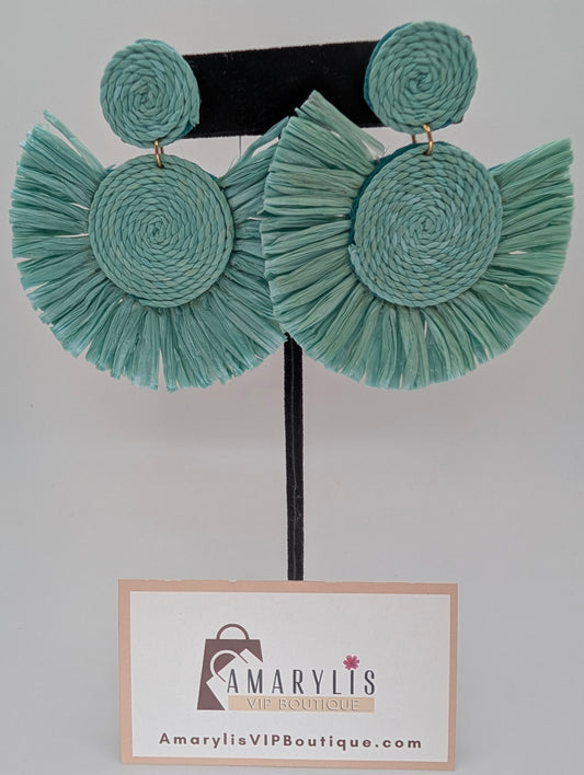 Teal raffia earrings on a hanger with Amarylis VIP Boutique label.