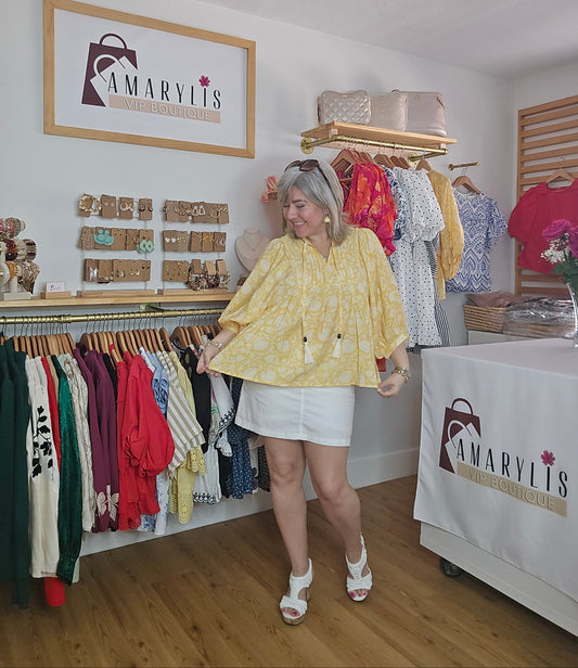 Yellow printed peasant blouse with puffed 3/4 sleeves and a tasseled tie neckline, lightweight and relaxed fit