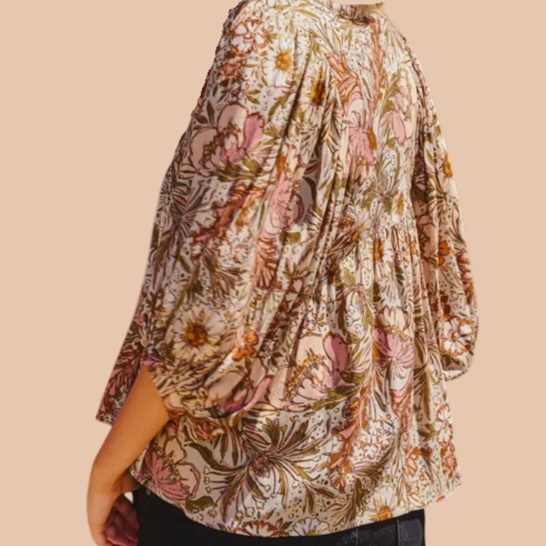 Bohemian floral peasant blouse with 3/4 puff sleeves and tassel tie neckline.