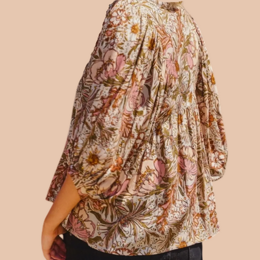 Bohemian floral peasant blouse with 3/4 puff sleeves and tassel tie neckline.