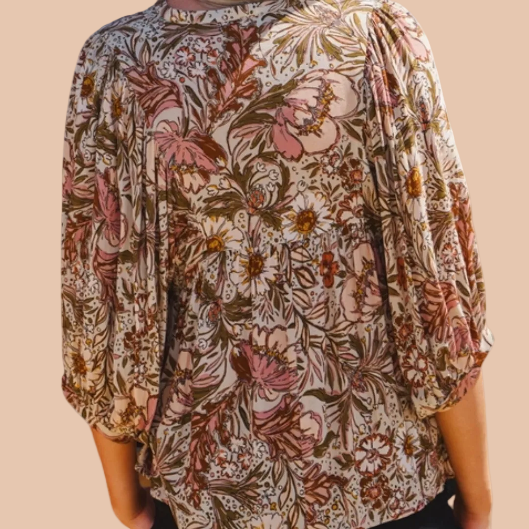 Bohemian floral peasant blouse with 3/4 puff sleeves and tassel tie neckline.