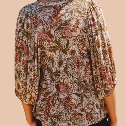 Bohemian floral peasant blouse with 3/4 puff sleeves and tassel tie neckline.