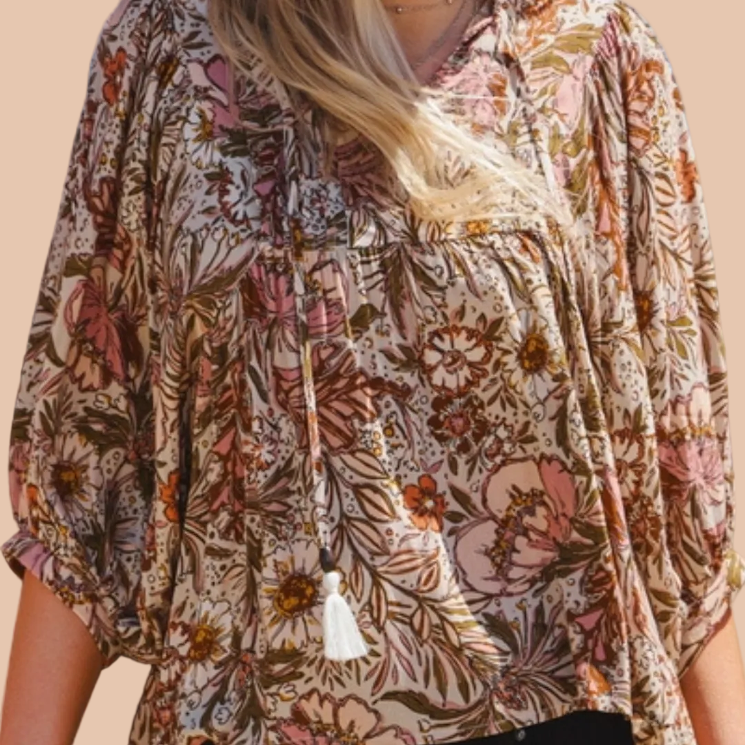 Bohemian floral peasant blouse with 3/4 puff sleeves and tassel tie neckline.