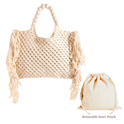 Large woven macrame tote bag with intricate knotted design, long fringe trim, and braided shoulder strap.