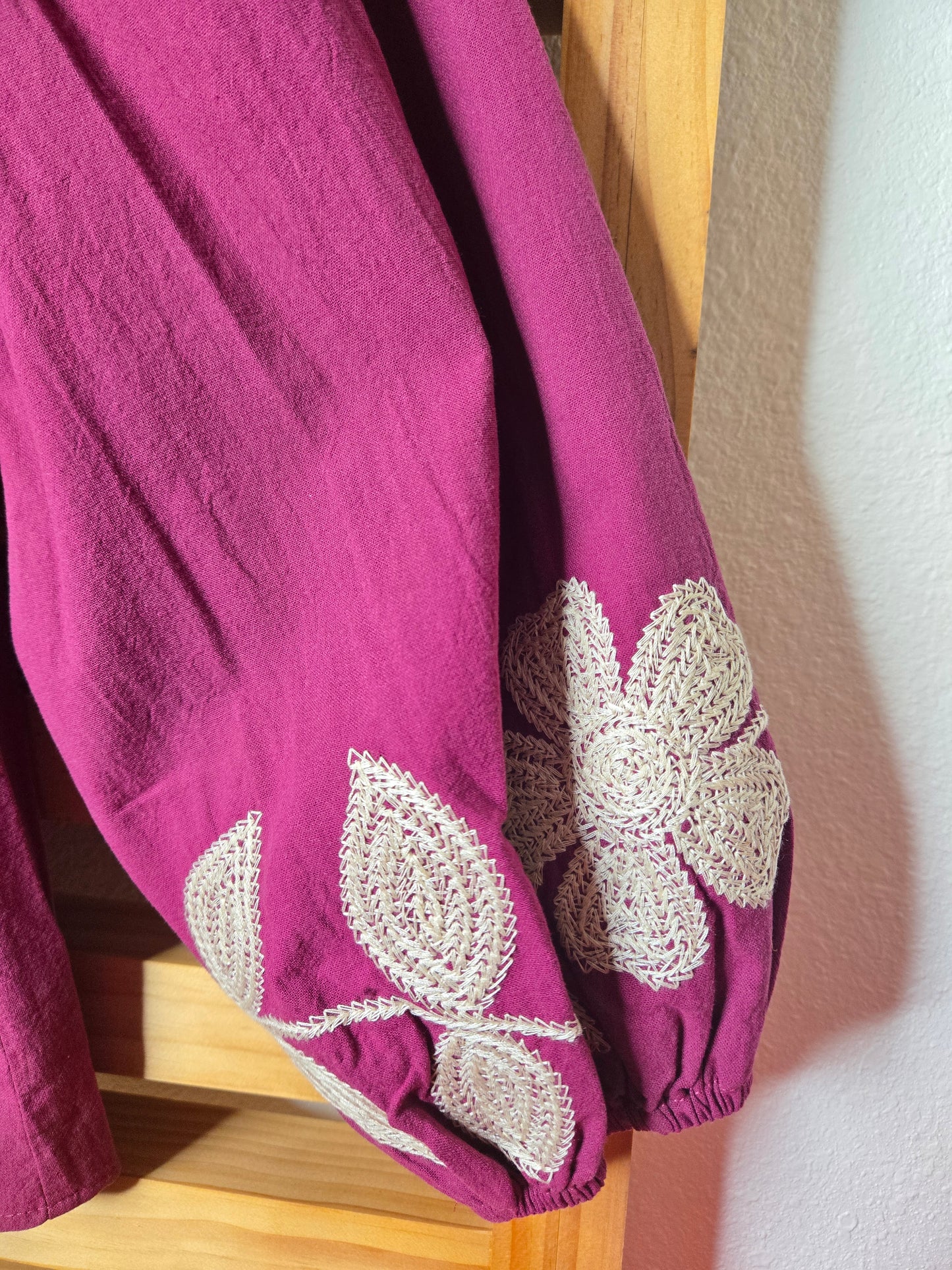 Magenta cotton blouse with floral embroidery, button-down front, and long sleeves