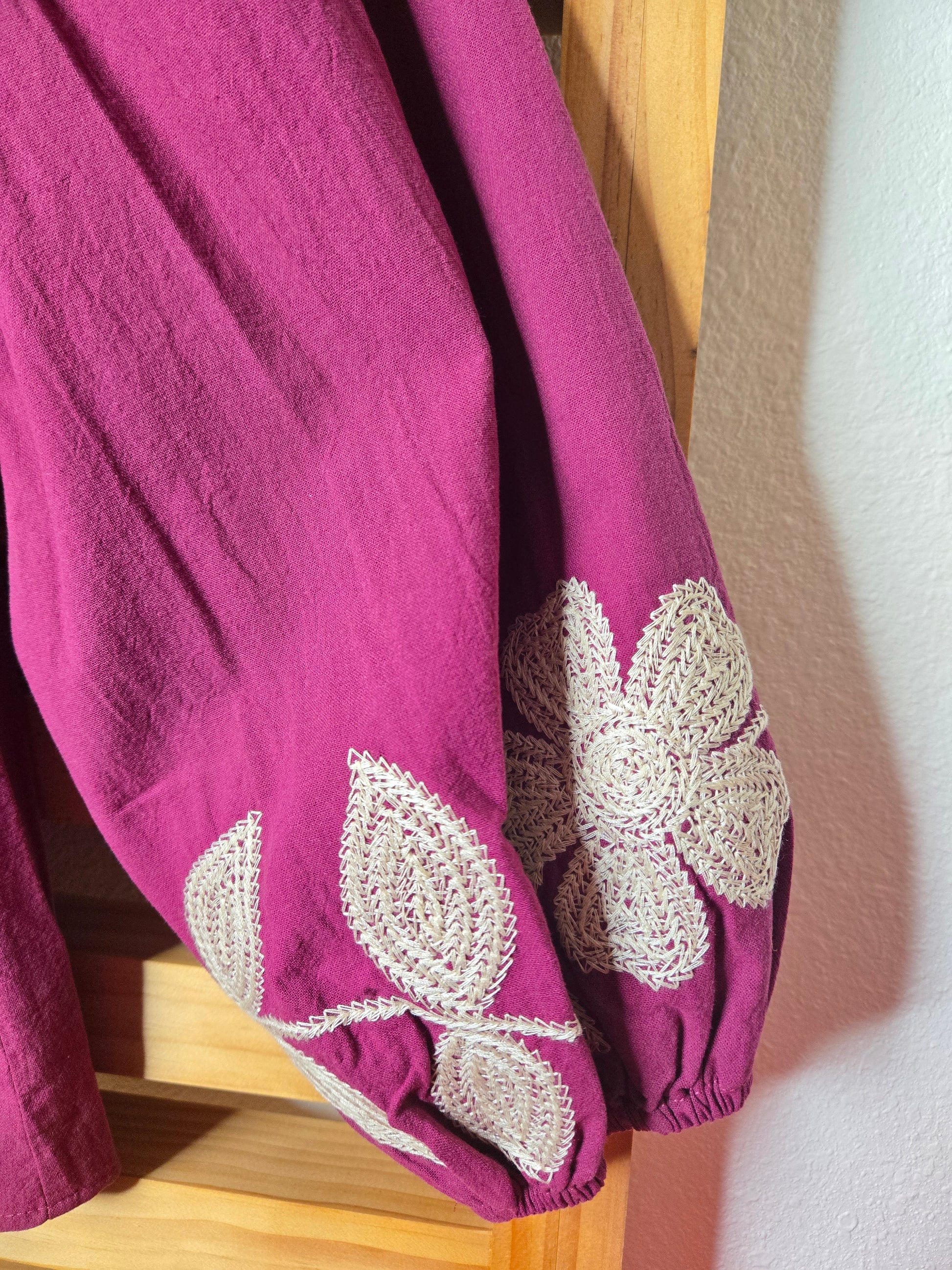 Magenta cotton blouse with floral embroidery, button-down front, and long sleeves