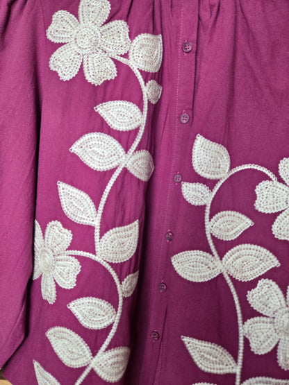 Magenta cotton blouse with floral embroidery, button-down front, and long sleeves