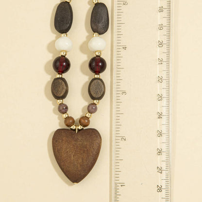 Wooden bead necklace featuring a heart-shaped pendant with a feminine and bohemian-inspired design.