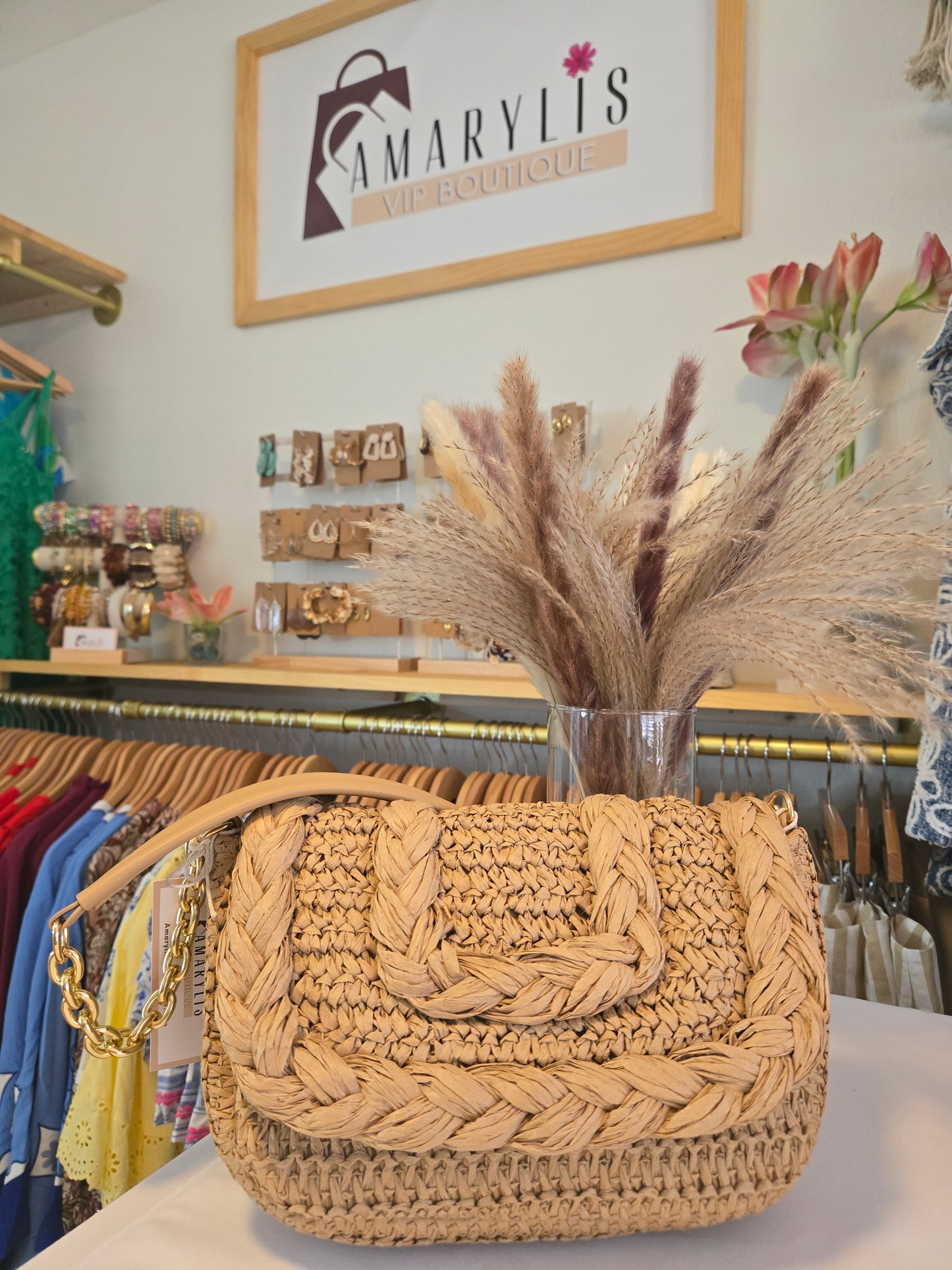 Woven raffia flap shoulder bag with textured natural fibers and structured silhouette