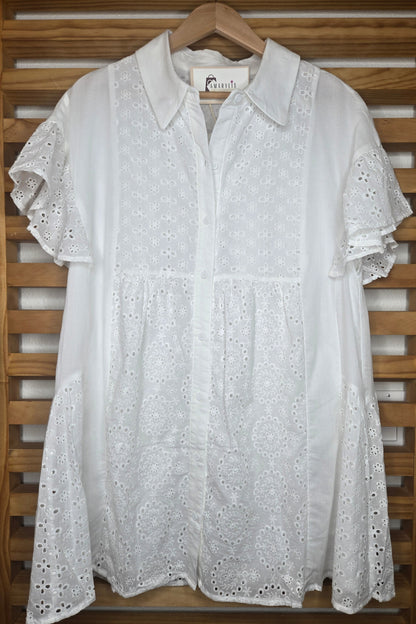 Lightweight shirt dress with eyelet embroidery, button-front closure, short flutter sleeves, and a soft, feminine silhouette.