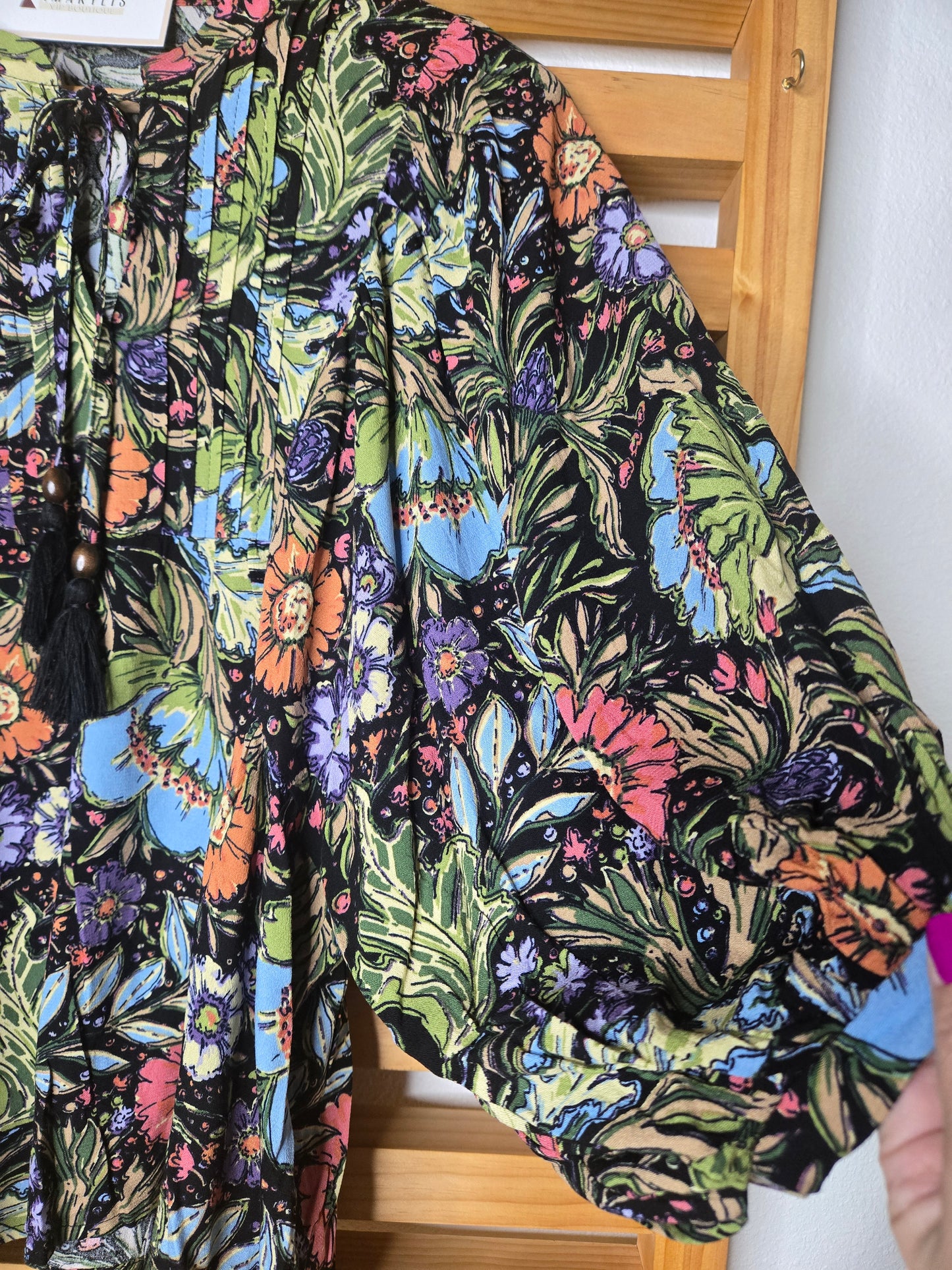 Soft and feminine peasant-style blouse featuring a delicate floral print, 3/4 length puff sleeves, and a tassel-tie neckline. Designed for effortless bohemian looks, this blouse offers a relaxed fit that feels comfortable yet polished and romantic.