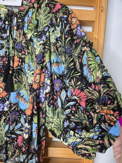 Soft and feminine peasant-style blouse featuring a delicate floral print, 3/4 length puff sleeves, and a tassel-tie neckline. Designed for effortless bohemian looks, this blouse offers a relaxed fit that feels comfortable yet polished and romantic.