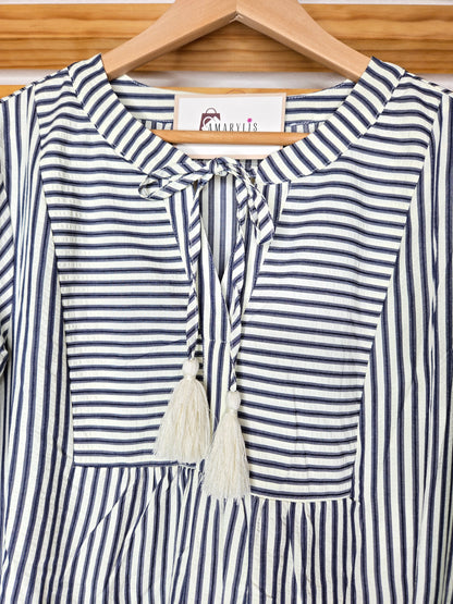 Navy striped cotton babydoll dress with bell sleeves, tassel tie neckline, relaxed fit silhouette, and functional side pockets.