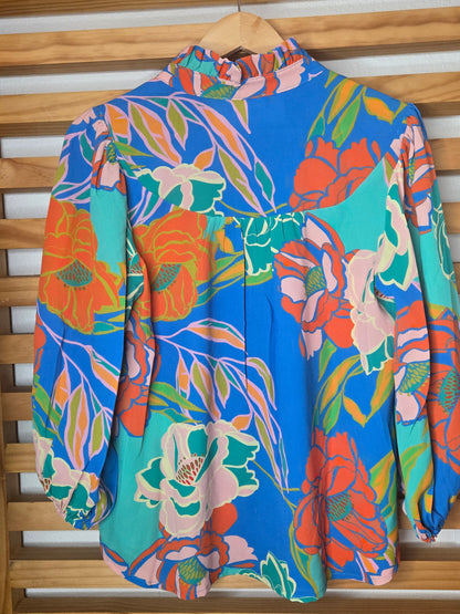 Floral printed blouse featuring 3/4 sleeves and a soft ruffled neckline detail.