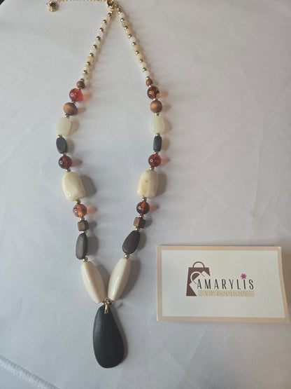 A timeless wood bead necklace with a graceful teardrop pendant, designed to bring natural beauty and effortless elegance to your wardrobe.