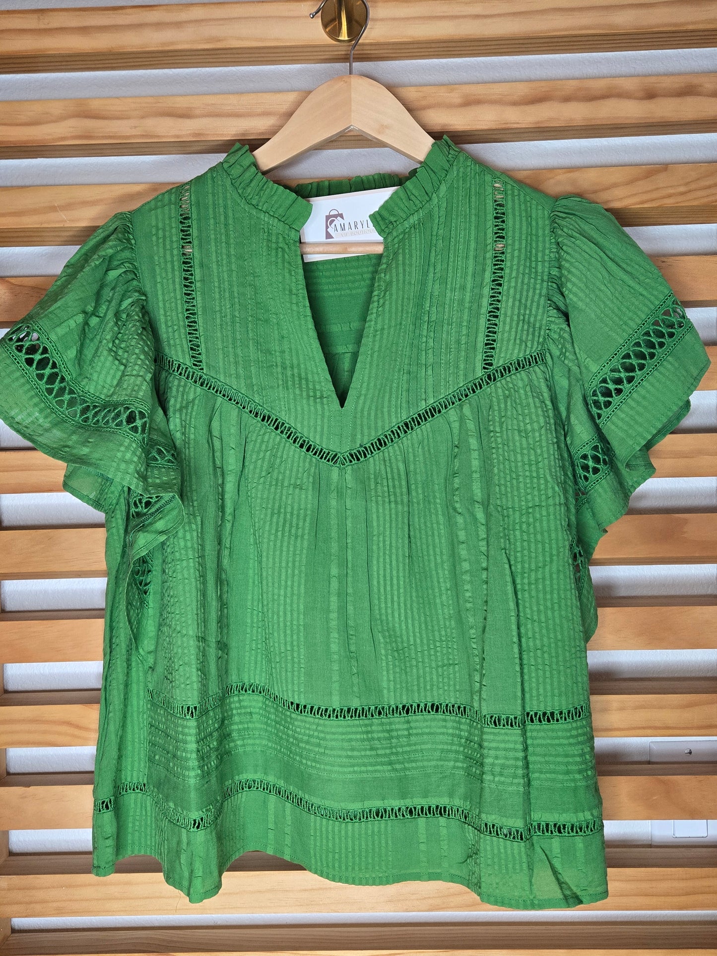 Designed with a flattering V-neckline, delicate lace accents, and soft short sleeves, this versatile piece combines comfort with timeless style. The lightweight fabric and relaxed silhouette make it easy to pair with jeans, shorts, skirts, or dress pants for both casual outings and polished everyday looks.