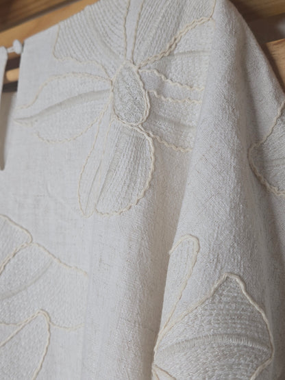 Beige linen-blend top with floral embroidery, featuring short dolman sleeves with elastic cuffs and a soft inner lining