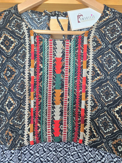 This piece is perfect for lovers of boho embroidered tops, mixed print blouses, and romantic bohemian clothing. A versatile short sleeve boho top designed for women who appreciate feminine, effortless style.