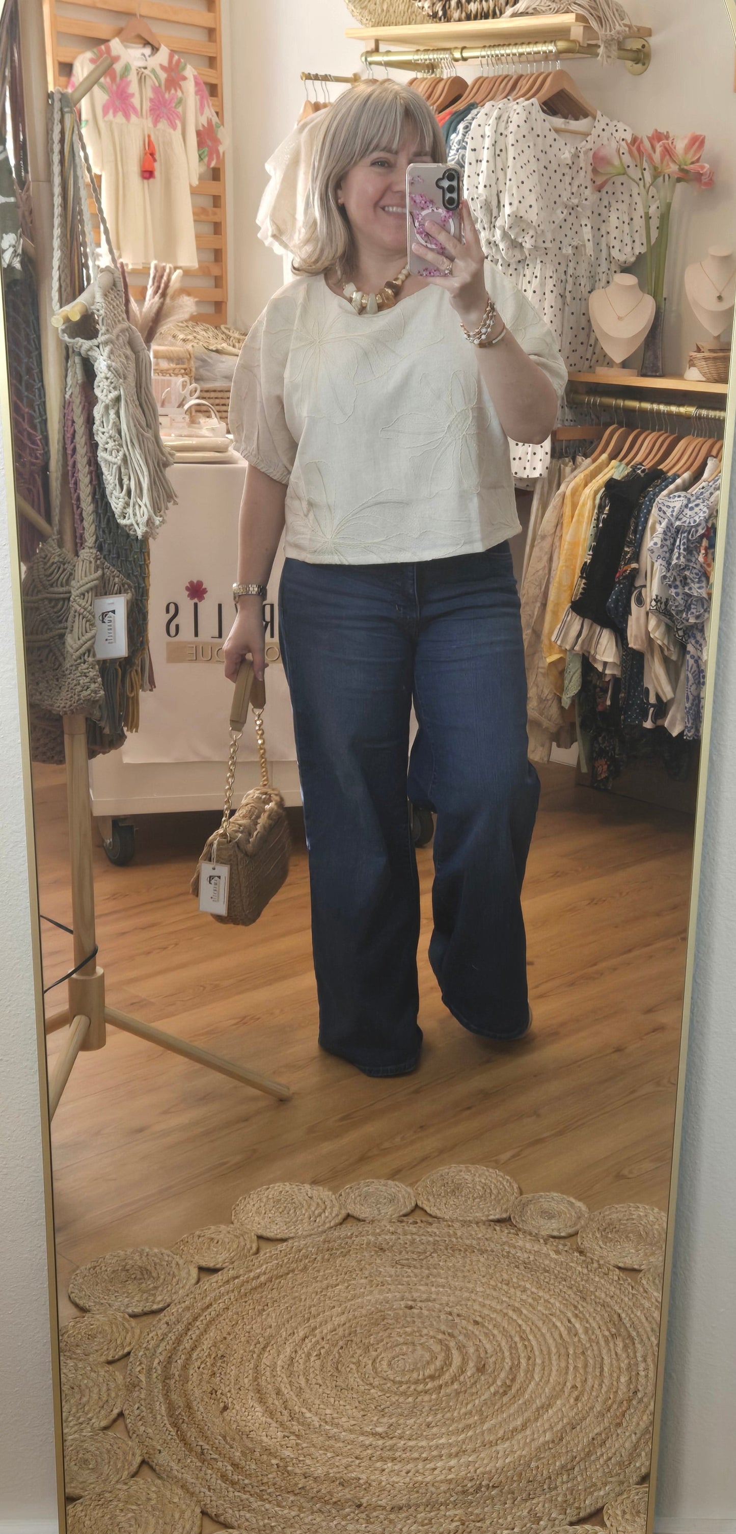 Beige linen-blend top with floral embroidery, featuring short dolman sleeves with elastic cuffs and a soft inner lining