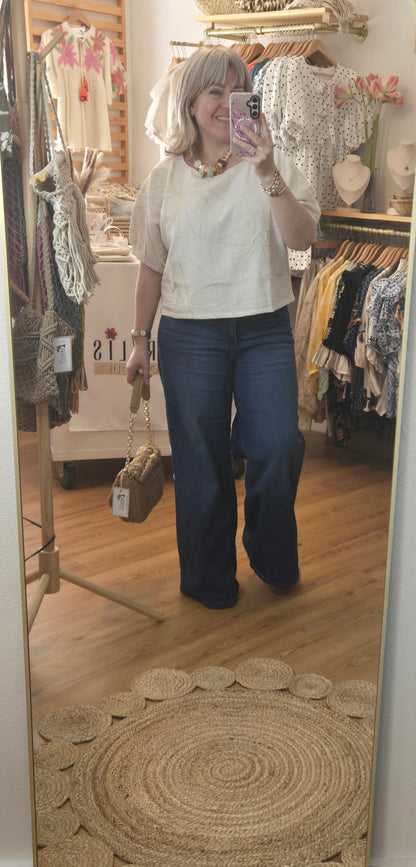 Beige linen-blend top with floral embroidery, featuring short dolman sleeves with elastic cuffs and a soft inner lining