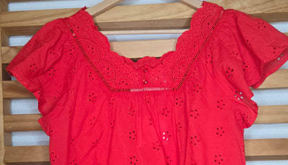 Women's red eyelet blouse with floral embroidery and short flutter sleeves.